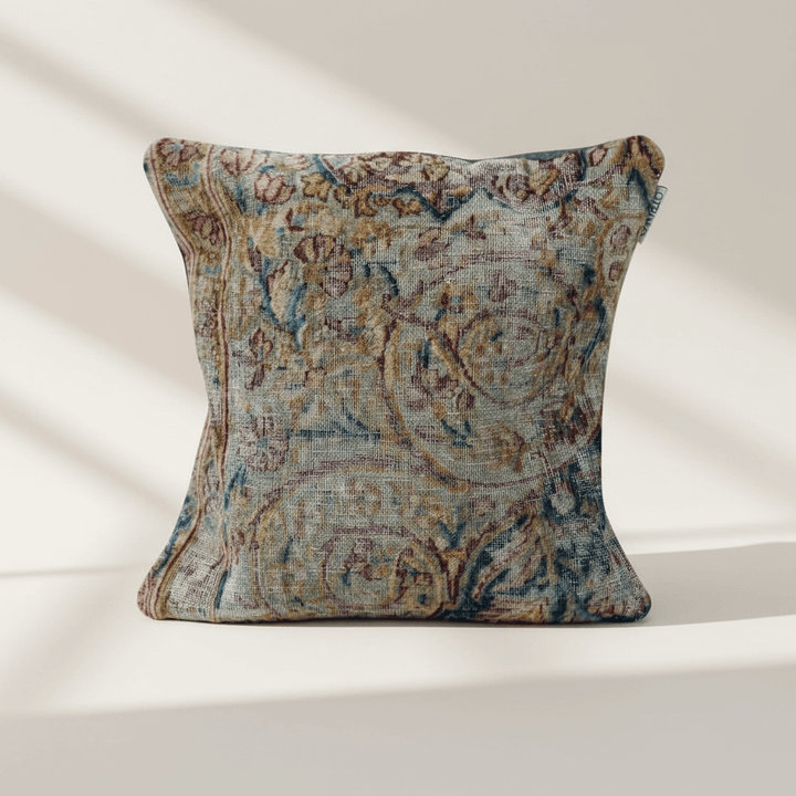 Decorative pillow with intricate paisley pattern on a white background