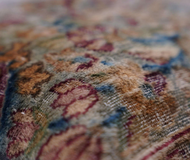 Close-up of a textured fabric with floral patterns in multicolors.