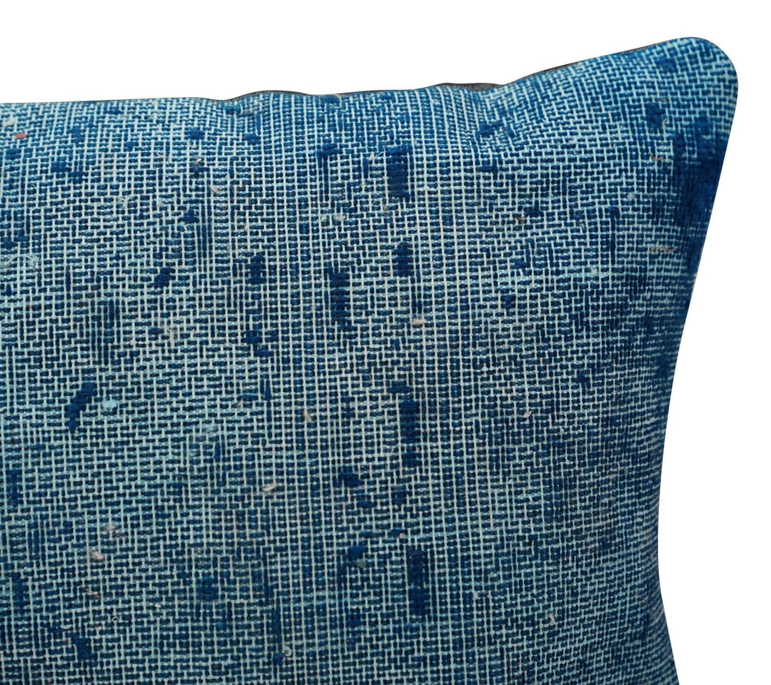 Blue textured pillow on a white background