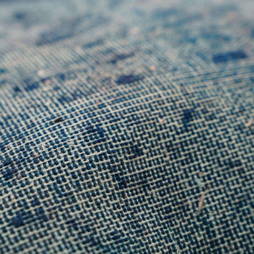 Close-up of textured fabric with a blue and beige pattern