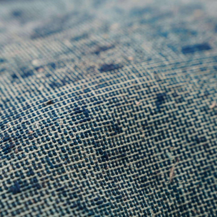 Close-up of textured fabric with a blue and beige pattern