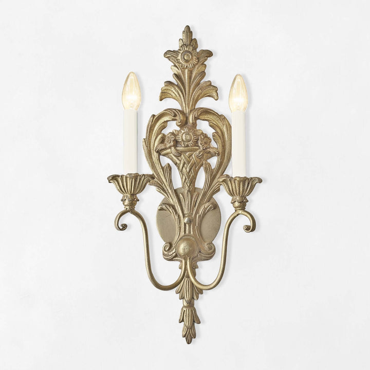 Decorative wall sconce with intricate design on a white background