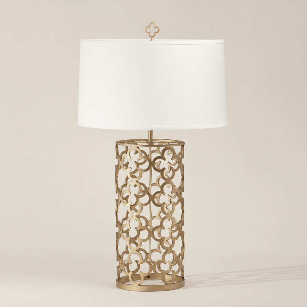 Decorative table lamp with intricate metal base and white shade on a beige background