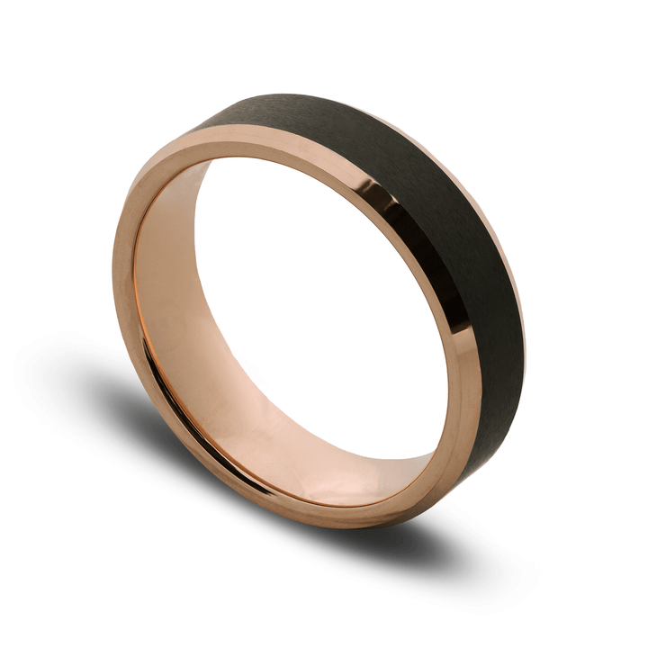 Two-tone ring with rose gold and black band on a white background