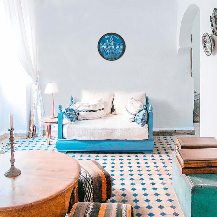 Living room with a blue sofa, patterned rug, and decorative elements.