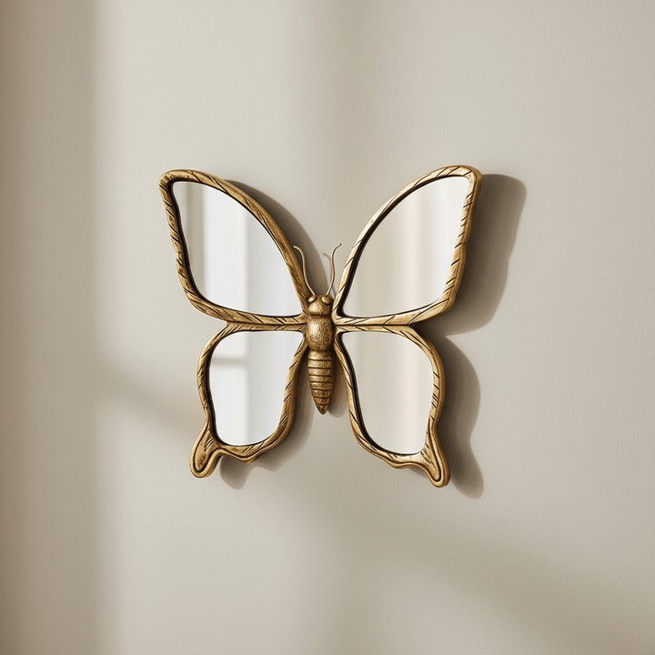 Decorative butterfly mirror with gold frame on a beige wall
