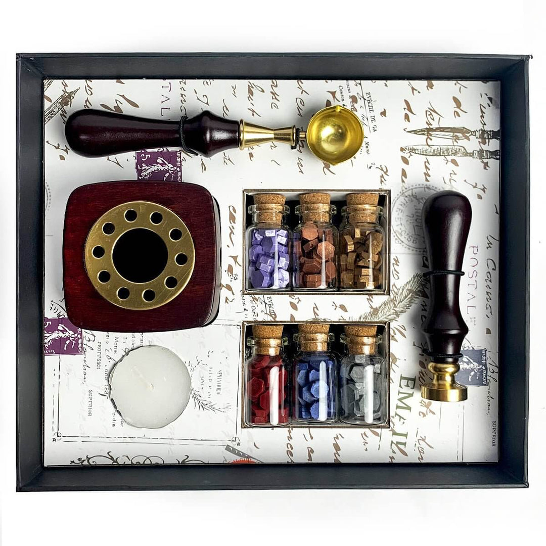 Wax sealing kit with a stamp, wax sticks, and sealing wax in a decorative box.