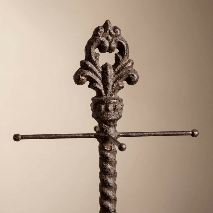 Close-up of the Bellavita measuring cup holder's fleur-de-lis finial, ball-ended arms and twisted metal stem