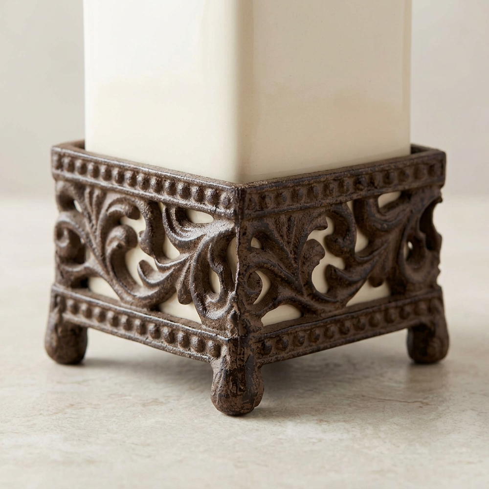 Close-up of the Bellavita dispenser's brown acanthus scroll holder and decorative feet