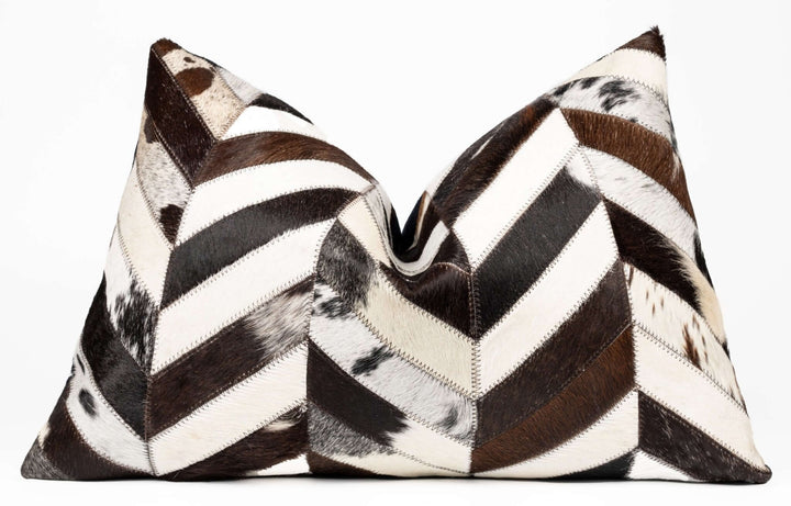Two decorative pillows with a chevron pattern in brown, black, and white on a white background.