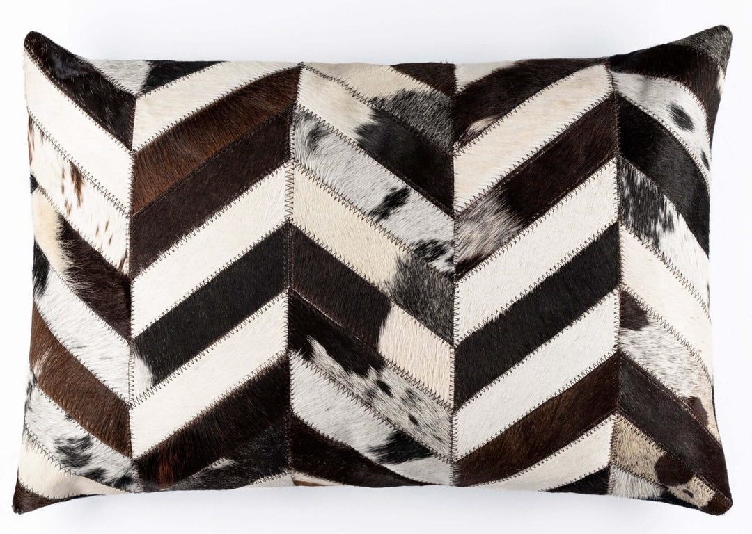 Chevron patterned pillow made of cowhide leather on a white background