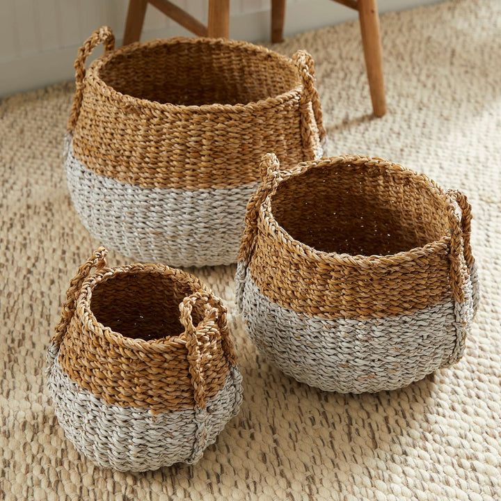 Boho Coastal Storage Baskets with Handles on a rattan carpet