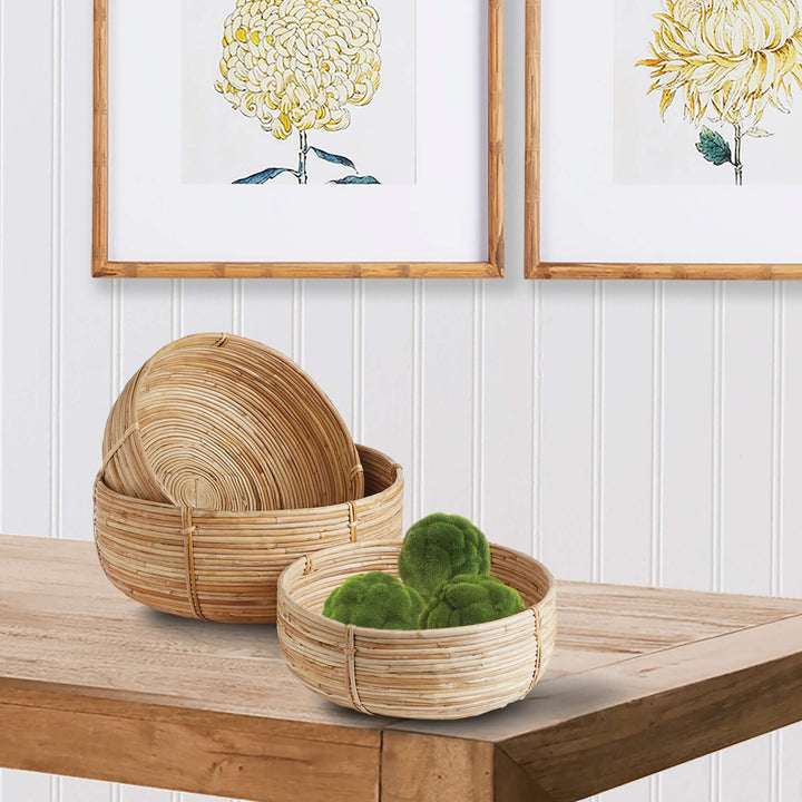 Boho Round Cane Rattan Nesting Bowls on table with artwork hung on wall behind