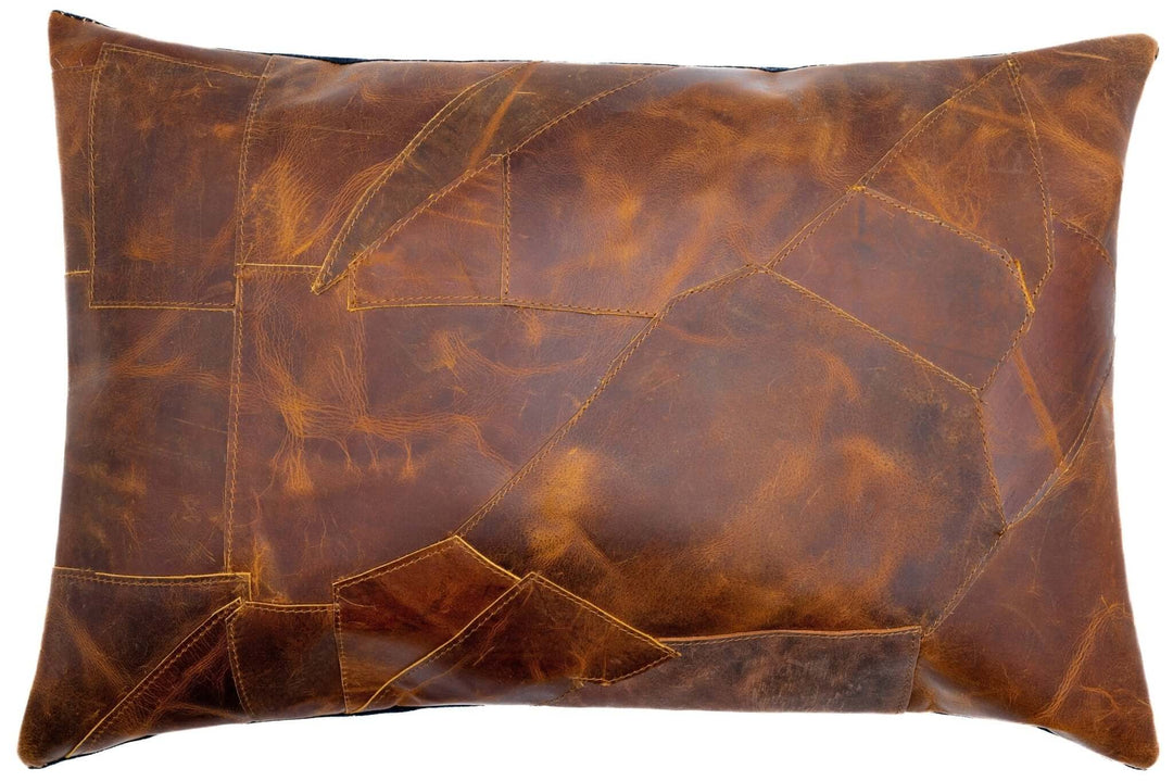 Brown leather pillow with patchwork design on a white background