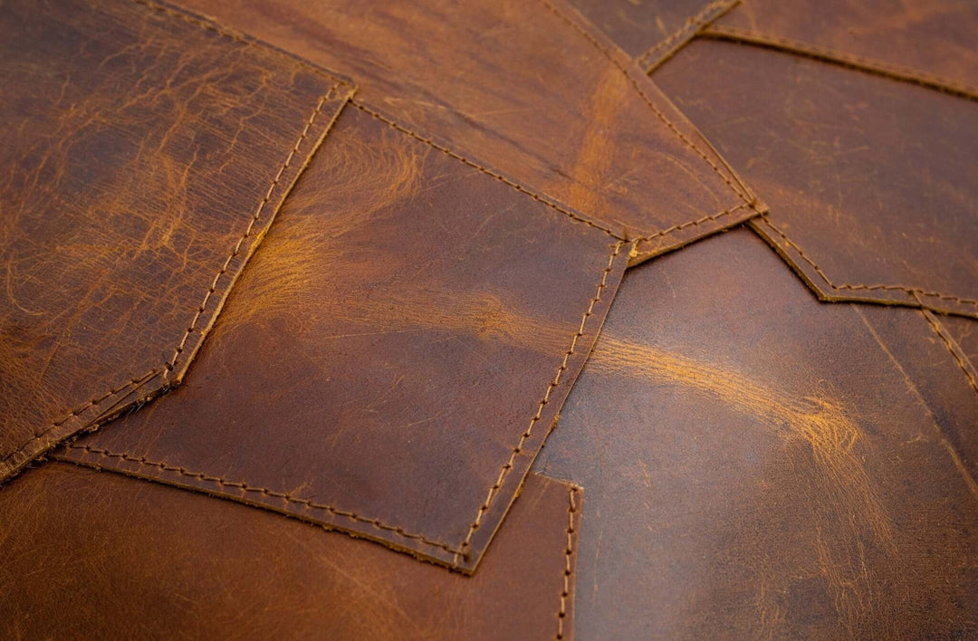 Close-up of brown leather with visible stitching