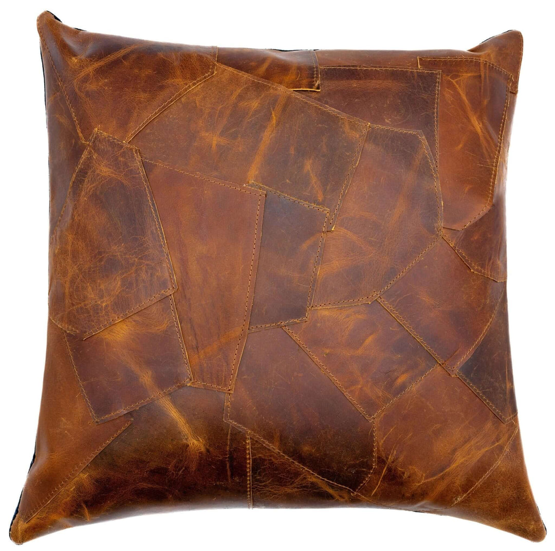 Brown leather patchwork pillow on a white background