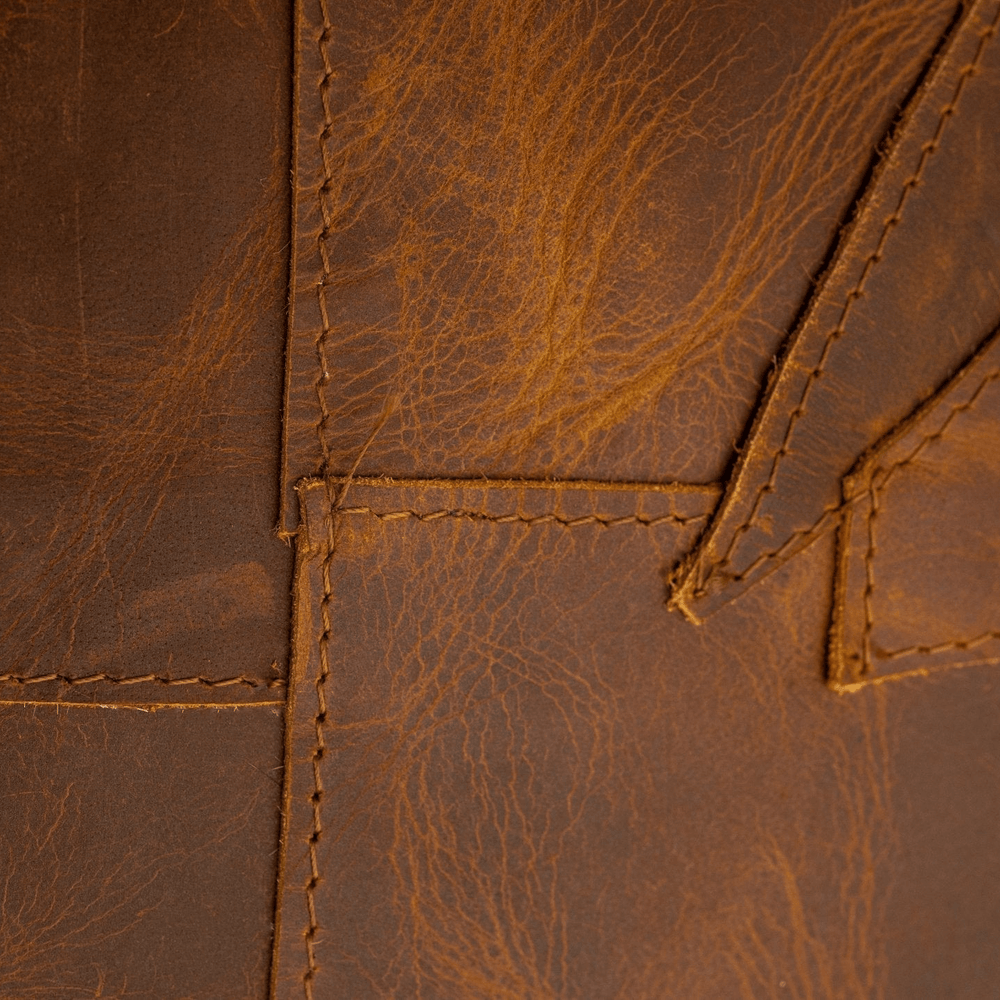 Close-up of brown leather with visible stitching