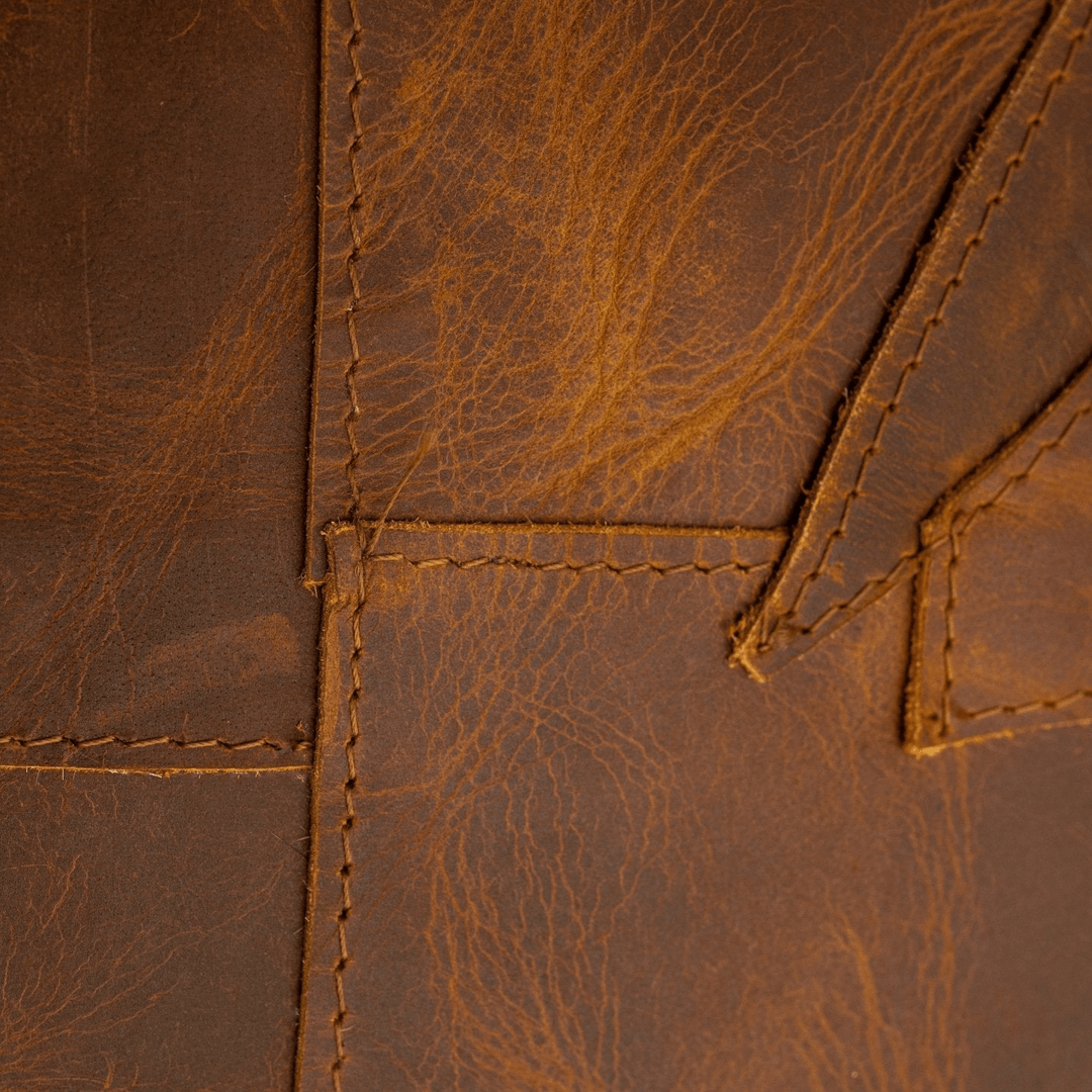 Close-up of brown leather with visible stitching