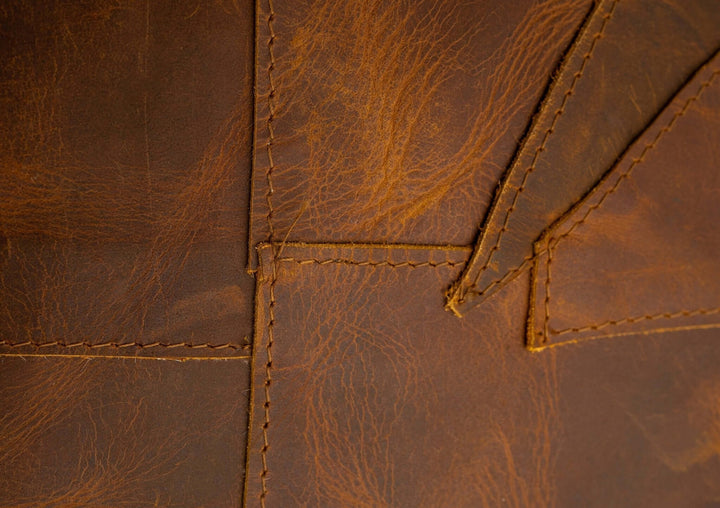 Close-up of brown leather with visible stitching
