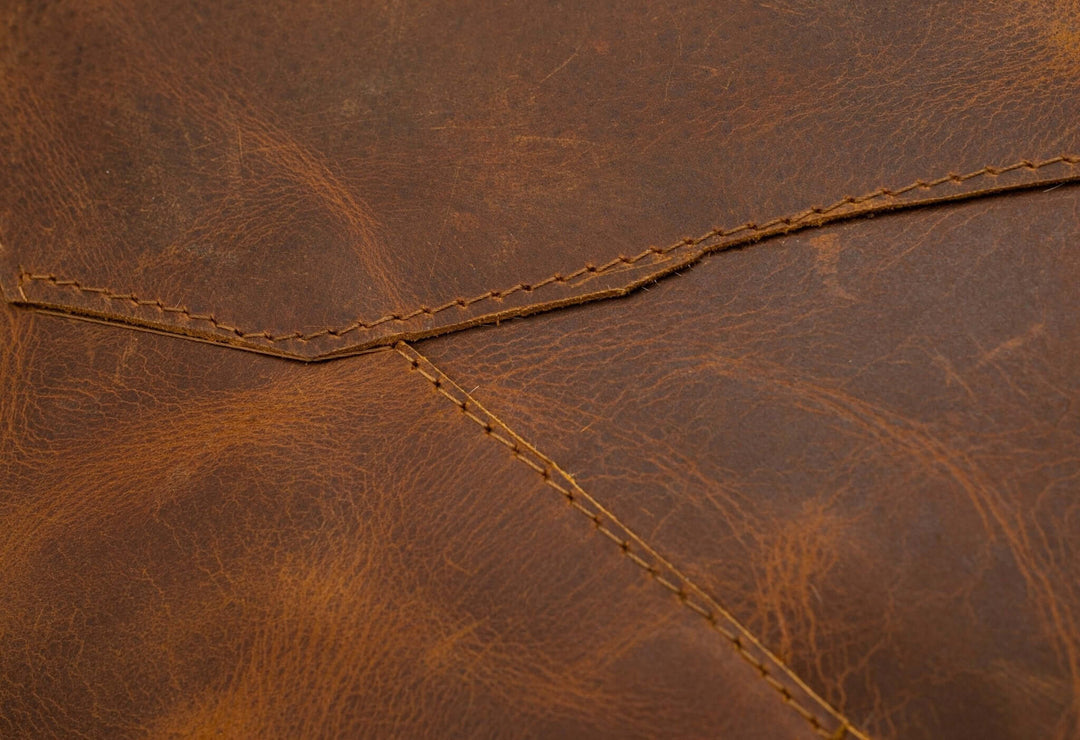 Close-up of brown leather texture with stitching