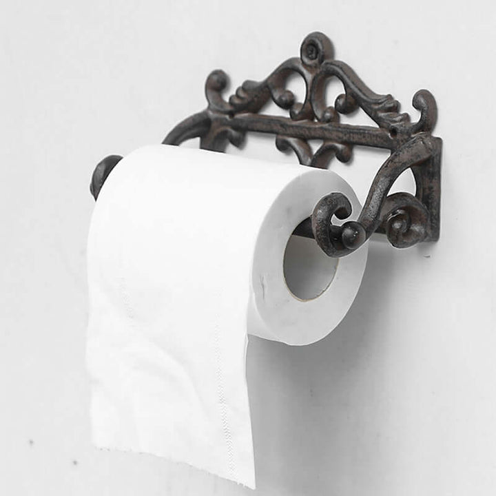 Decorative toilet paper holder with a roll of toilet paper on a white background