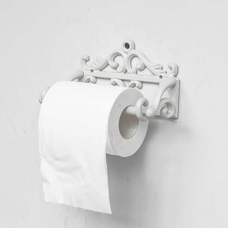 Decorative white toilet paper holder with two rolls of toilet paper on a light gray background