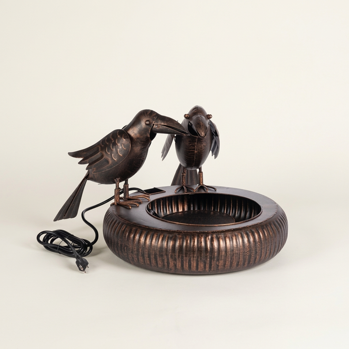 Black Bronze Chattering Crows Fountain photographed against a clean ivory studio background with both birds and the full basin visible.