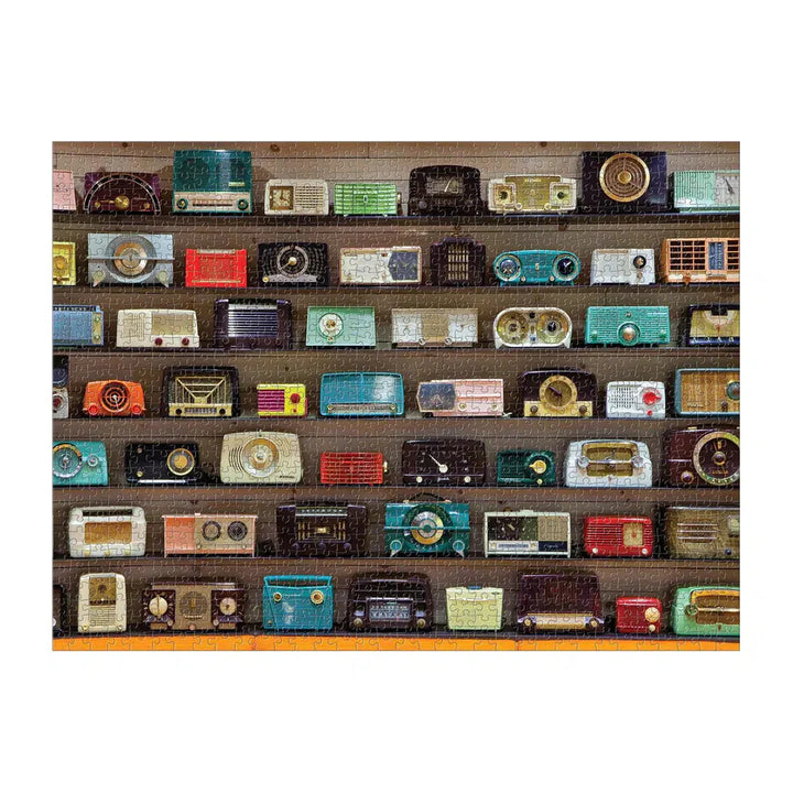 A puzzle showing a collection of vintage radios on wooden shelves with a white background
