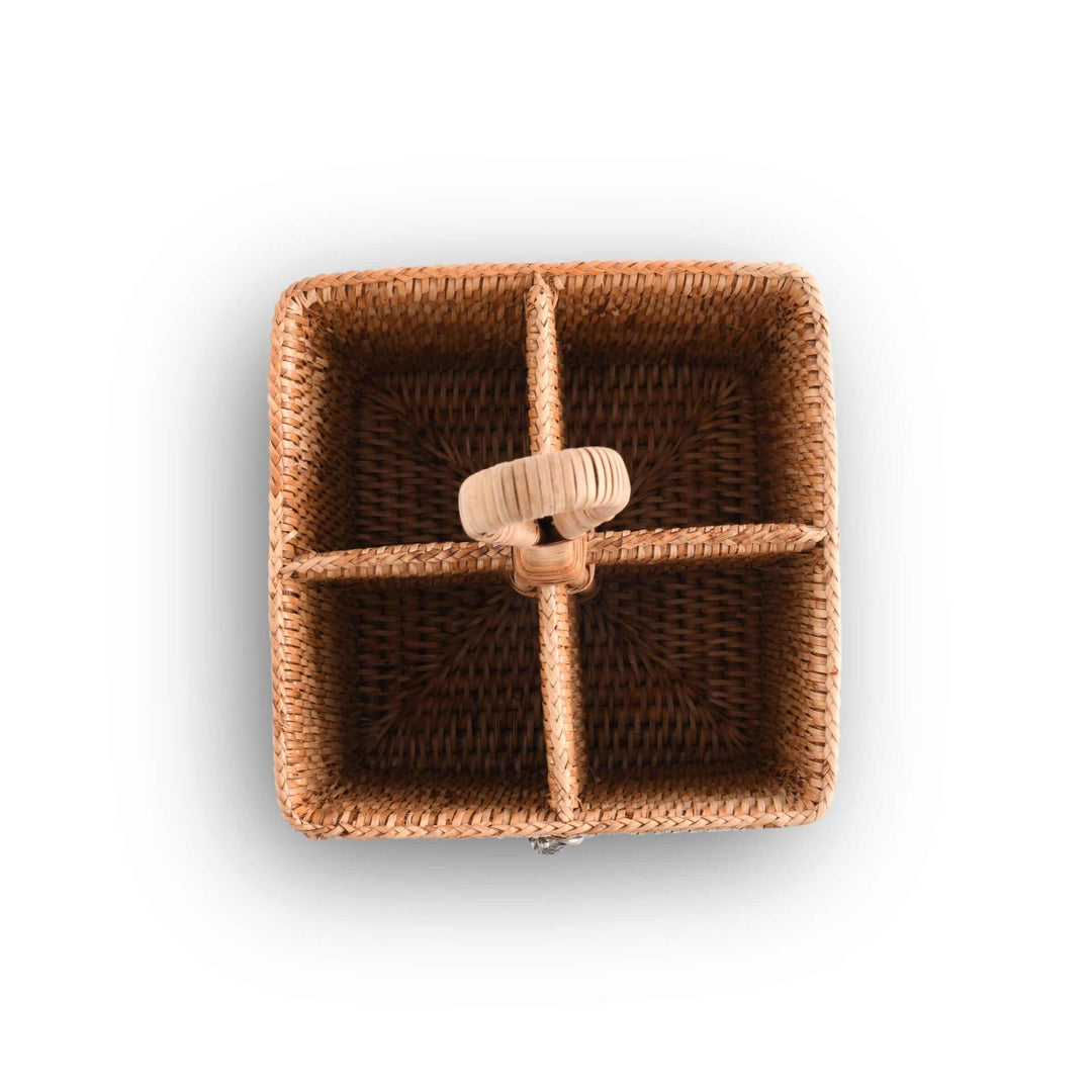 Woven rattan caddy with a central handle on a white background