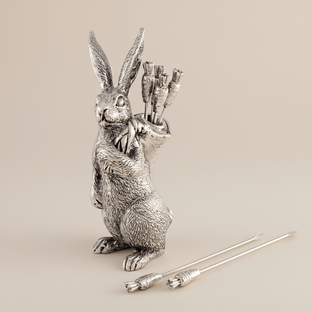 Silver rabbit-shaped pick holder with on a beige background