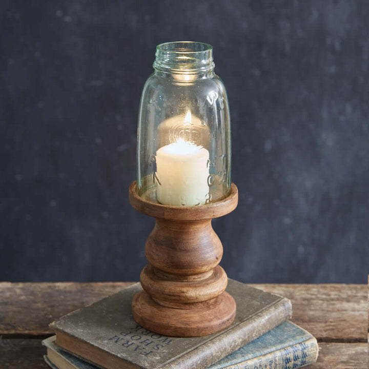 Rustic farmhouse candle holder with glass Mason jar and wooden base, creating a warm ambiance for home decor.