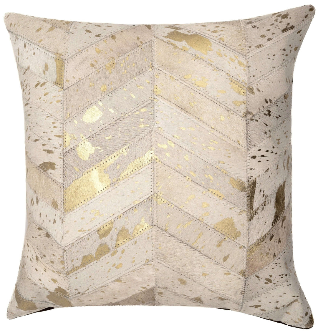 Decorative pillow with chevron pattern and gold accents on a beige background