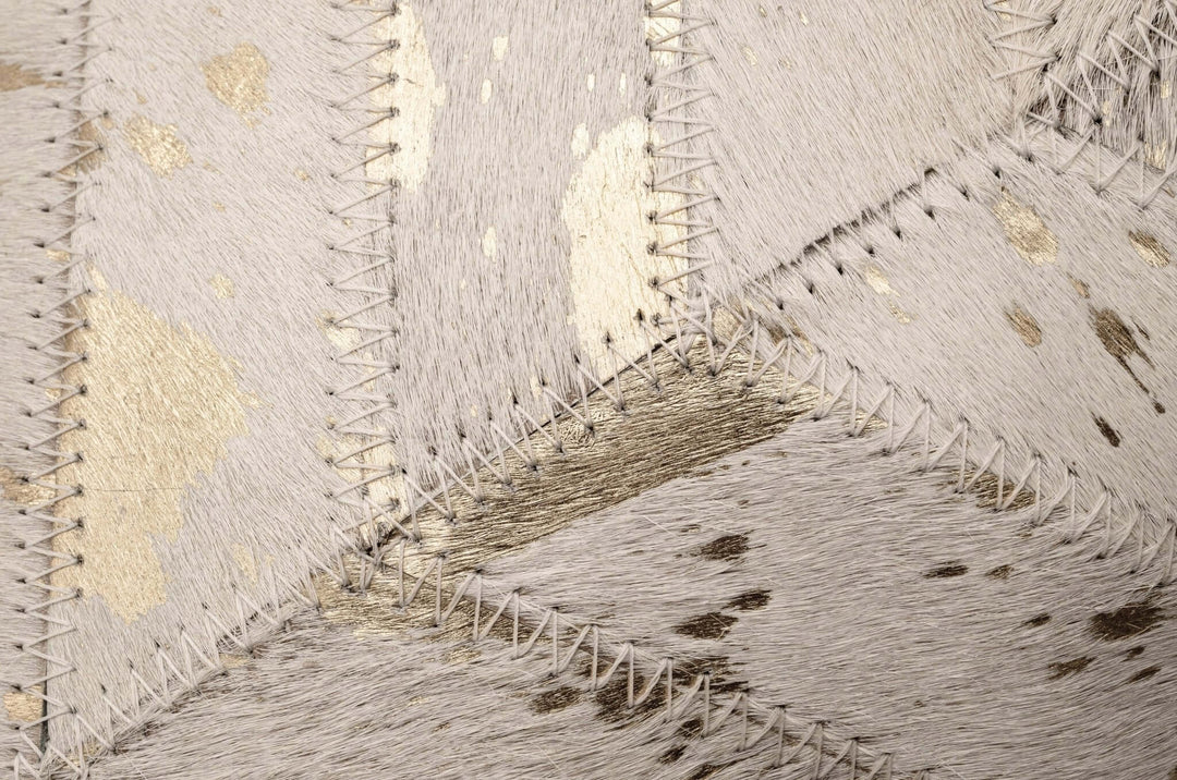 Close-up of a textured cowhide pillow with geometric pattern