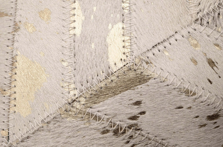 Close-up of a textured cowhide pillow with geometric pattern