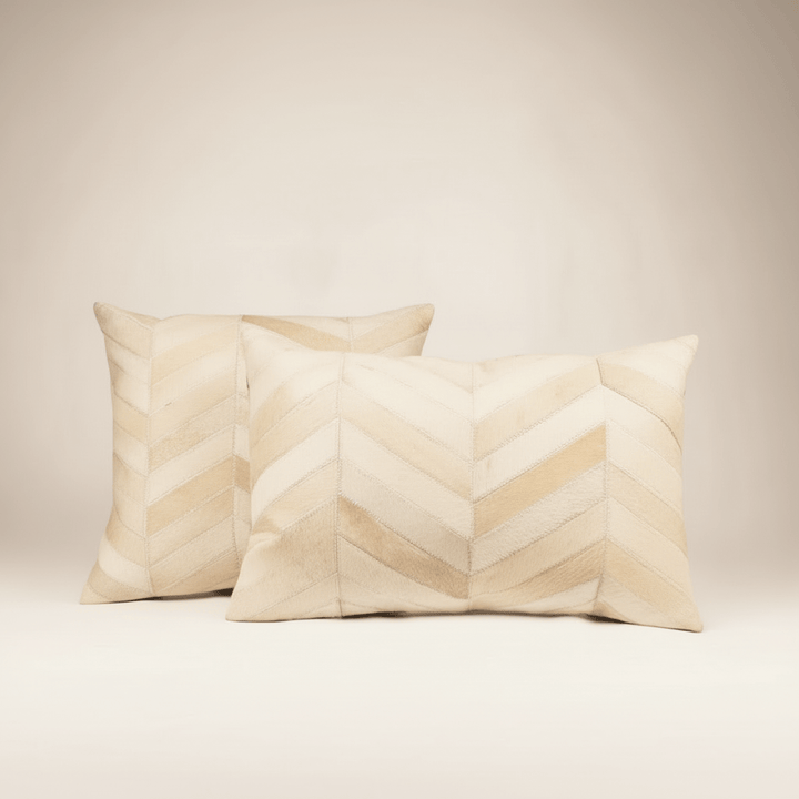 Two beige pillows with a chevron pattern on a light background