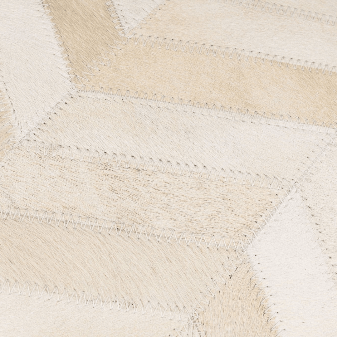 Close-up of a woven beige and white pillow  with a geometric pattern.