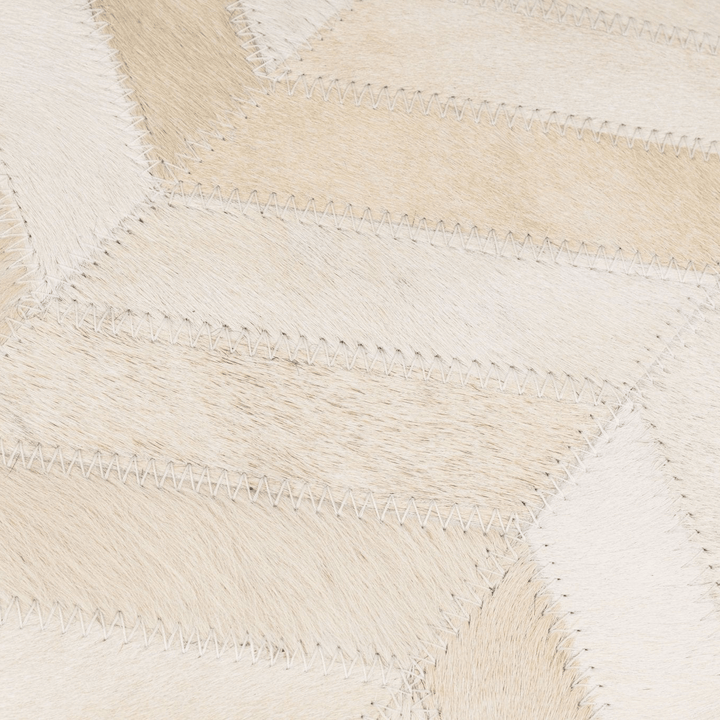 Close-up of a woven beige and white pillow  with a geometric pattern.