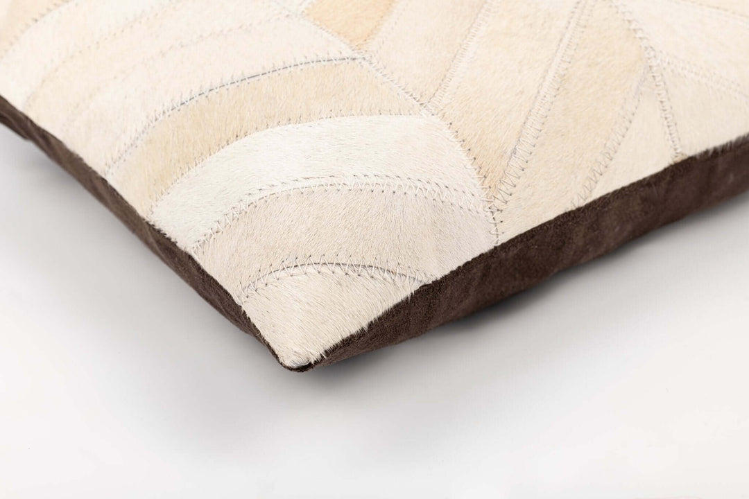 Close-up of a pillow with beige and brown pattern on a light gray background