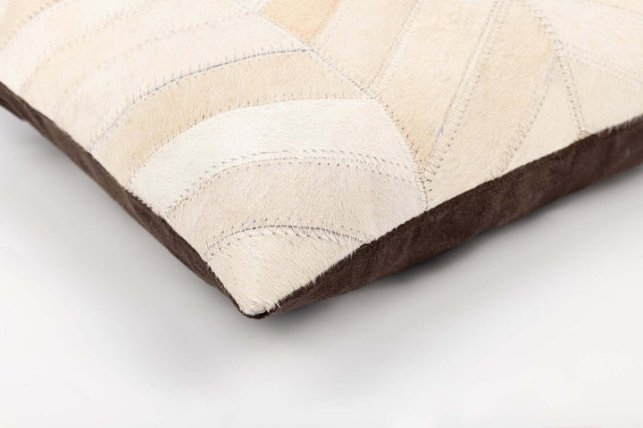 Close-up of a pillow with beige and brown pattern on a light gray background