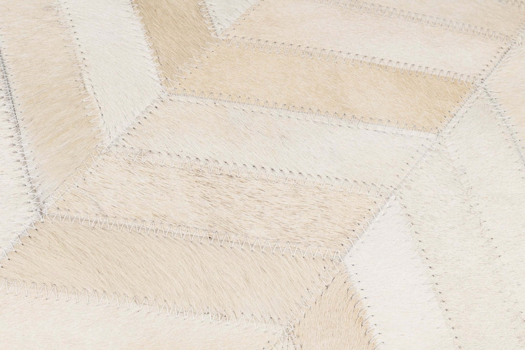 Close-up of a textured fabric with a diamond pattern in beige and white.