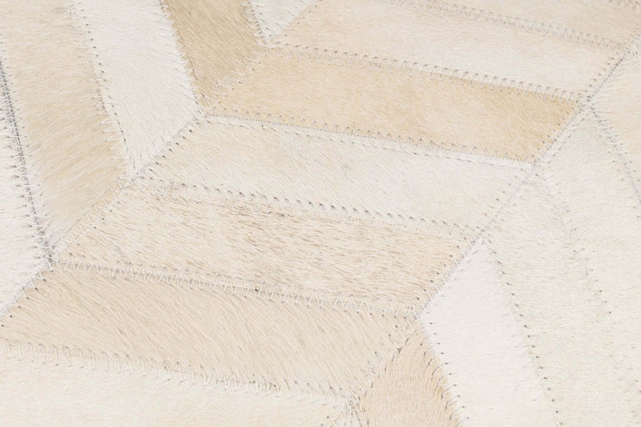 Close-up of a textured fabric with a diamond pattern in beige and white.