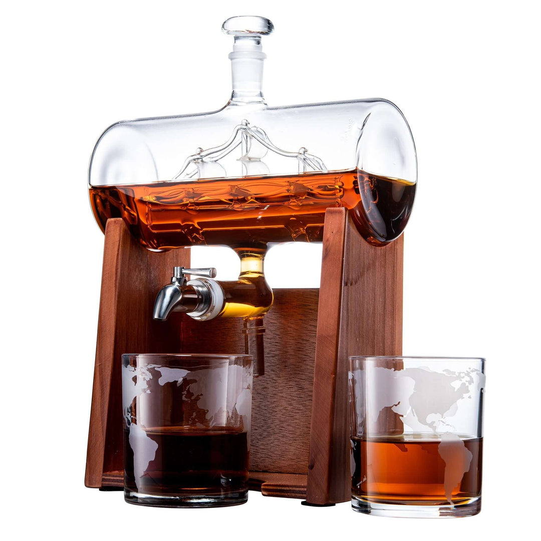 Glass decanter with wooden base and two glasses filled with amber liquid on a white background