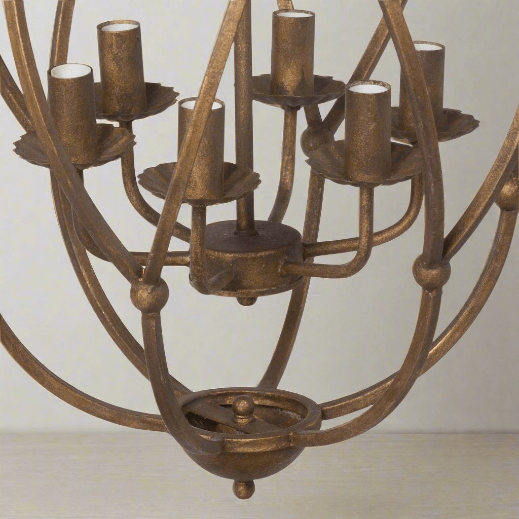 Bronze chandelier with multiple light holders on a plain background