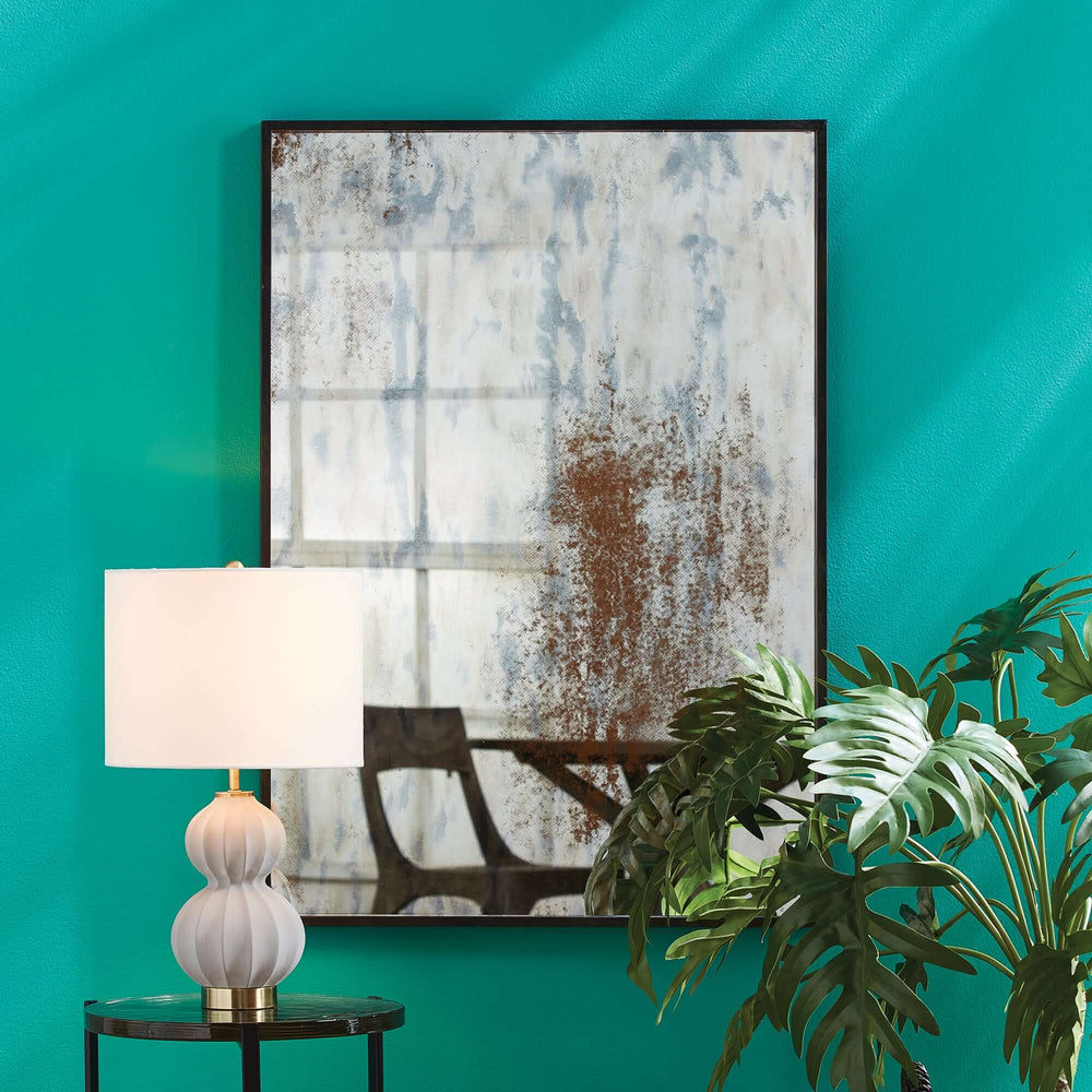Distressed Vintage Wall Mirror for Entryway or Foyer hung on a wall with a lamp and plant in front of it