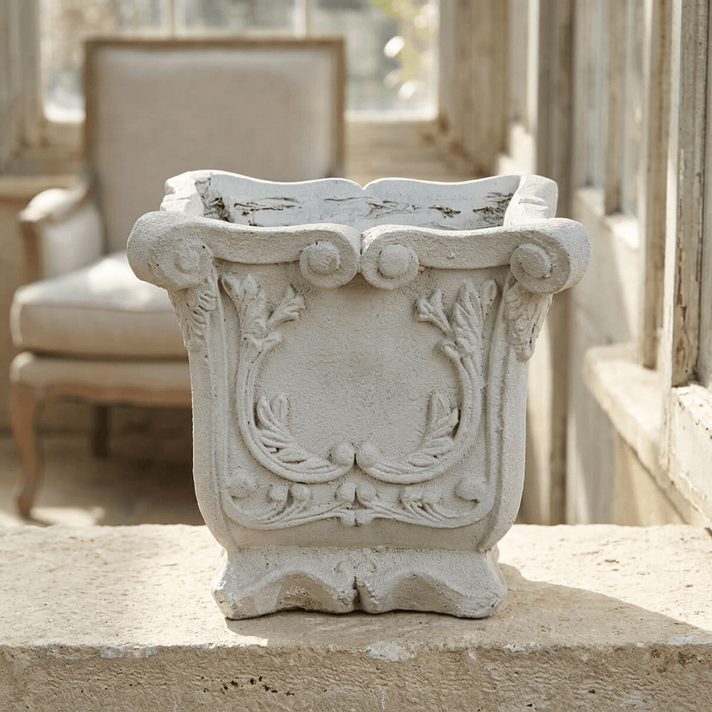 Duchess square laurel planter displayed empty on a limestone ledge in a softly lit sunroom.