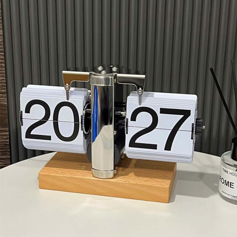 Flip clock with wooden base displaying the numbers 20 and 27 on a neutral background.
