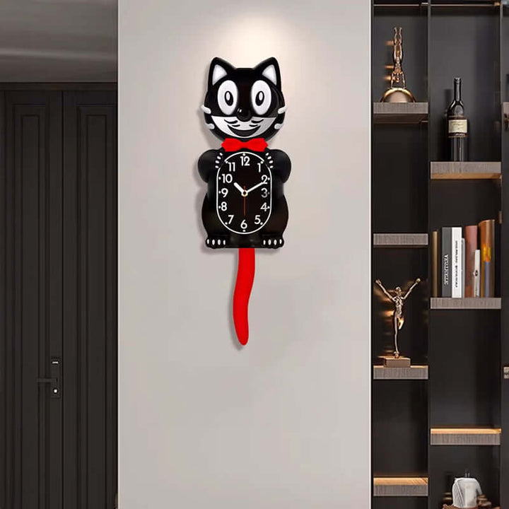 Cat-shaped wall clock with a red tail on a white wall next to a bookshelf.