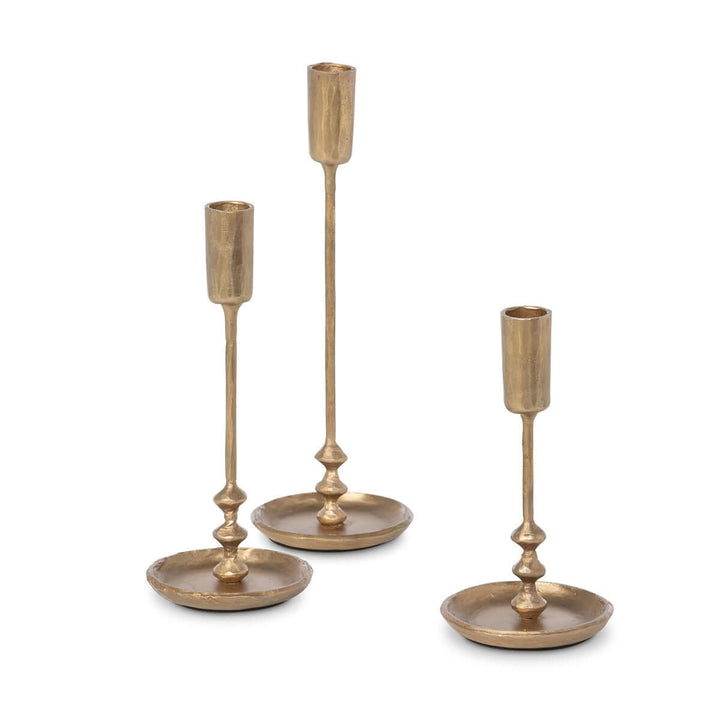 Set of three vintage antique gold iron taper candle holders with elegant design and graduated heights for classic home decor.