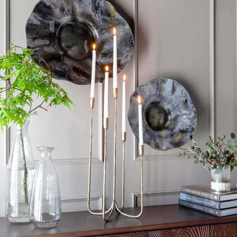 Tall Vintage Brass Candelabra on modern tabletop with artistic decor in background