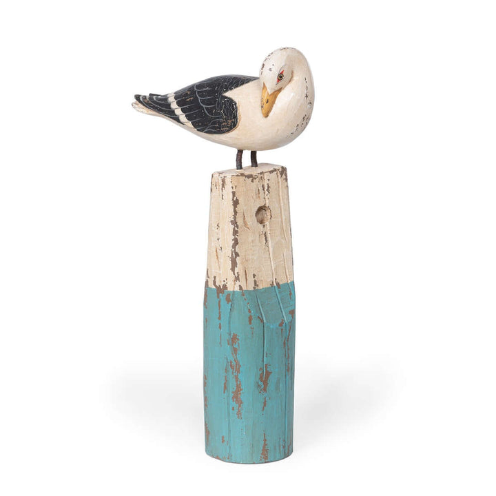 Vintage seagull figurine on buoy, handcrafted from beechwood in turquoise, ivory, and black, adding coastal charm to home decor.
